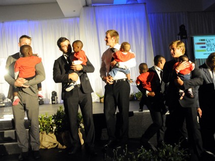 Golden Lions rugby players show off the little ones as a perfect ahh moment to start the event