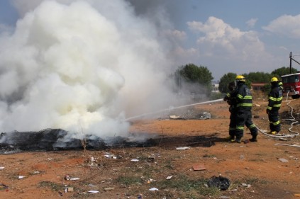 Firefighters put out the fire next to the Randburg Taxi Rank on 23 October.