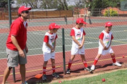 Neil McKenzie trains a batman to hit a ball through the legs of the players far away.